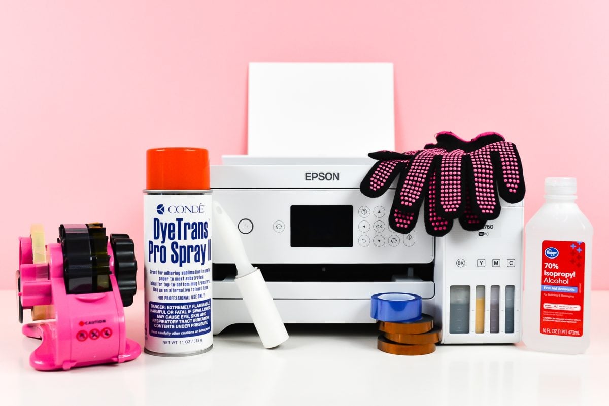 Sublimation printer surrounded by supplies in this post.