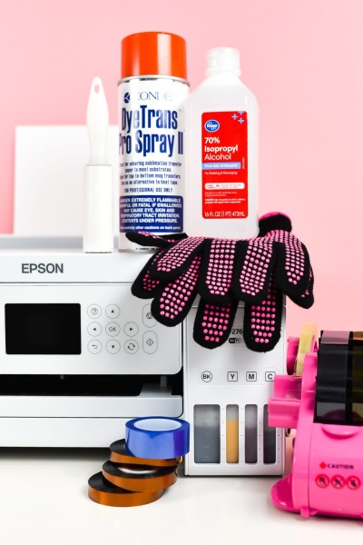Sublimation printer surrounded by supplies in this post.