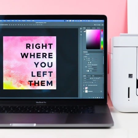 Open laptop showing Photoshop next to printer