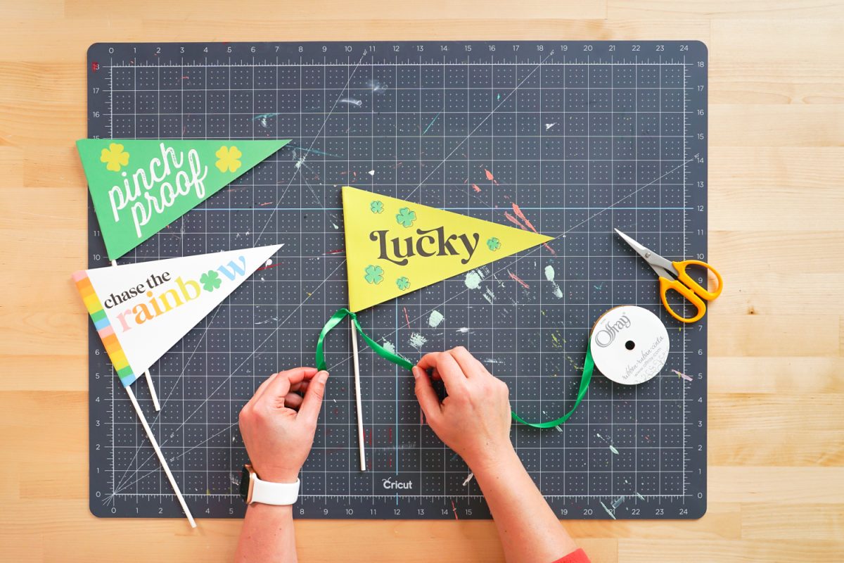 tying ribbon to pennant flag