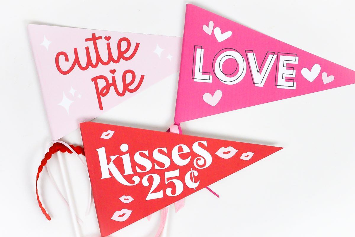 Three printable valentine's day pennants on white table