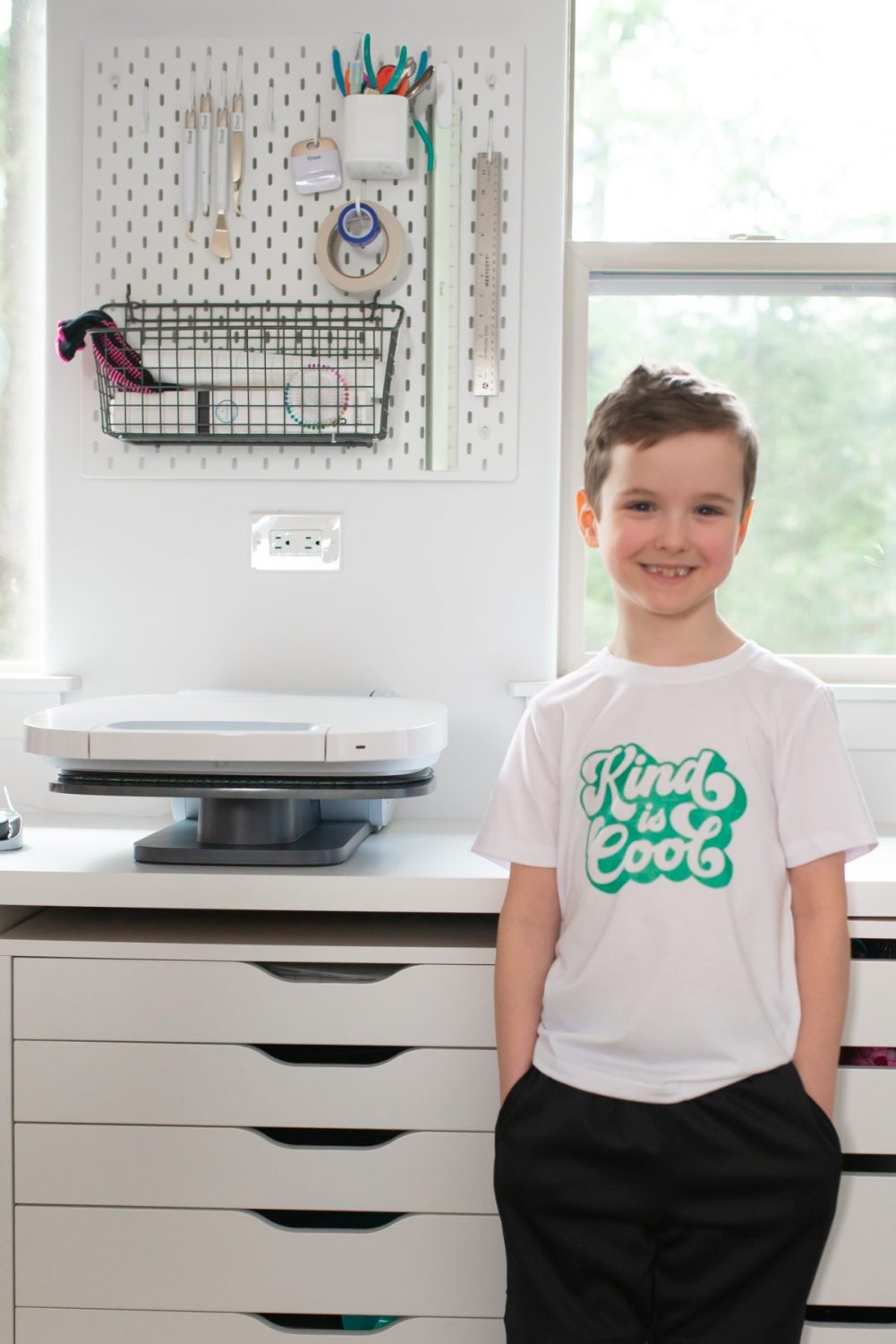 Young boy wearing Kind is Cool t-shirt made with press.