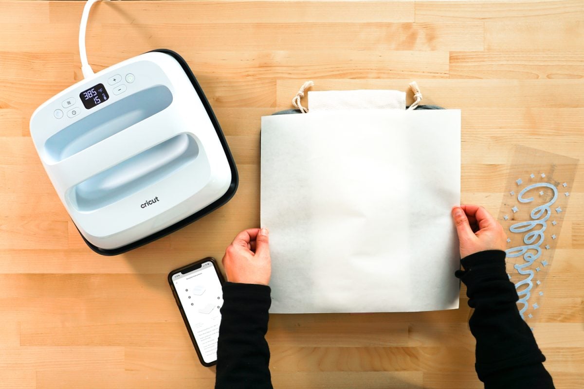 Hands placing butcher paper over the bag.