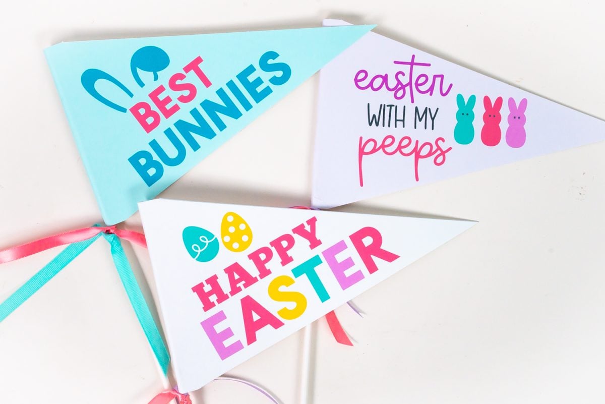 Three of the printable easter pennants on a white table.