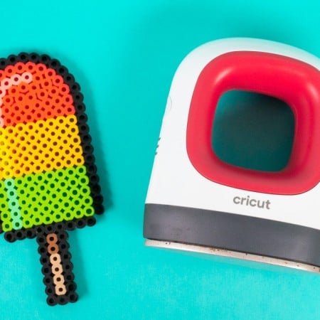 Perler bead popsicle and EasyPress Mini on a teal background