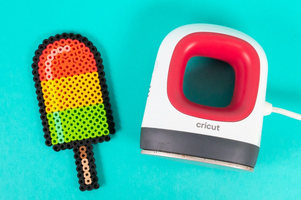 Perler bead popsicle and EasyPress Mini on a teal background