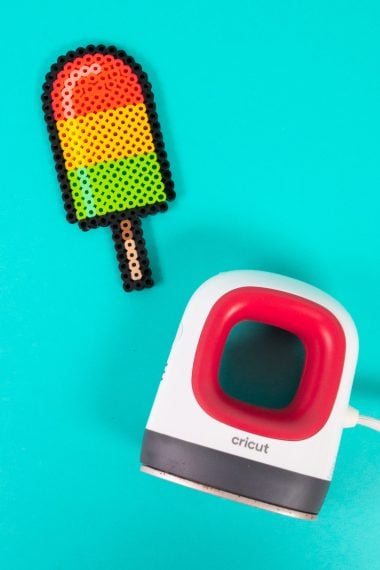 Perler bead popsicle and EasyPress Mini on a teal background