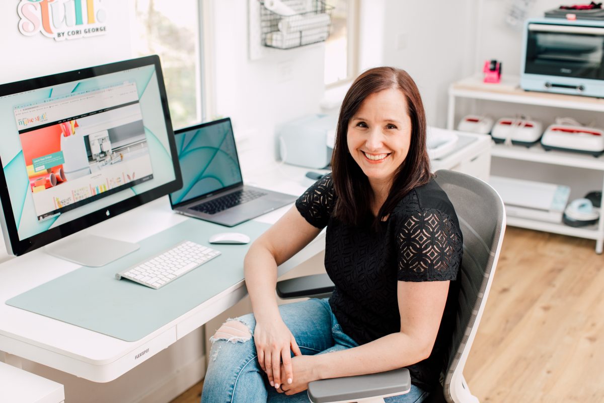 Cori George sitting at a desk.