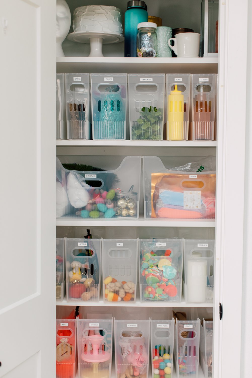 Closet with clear bins holding all sorts of crafty stuff