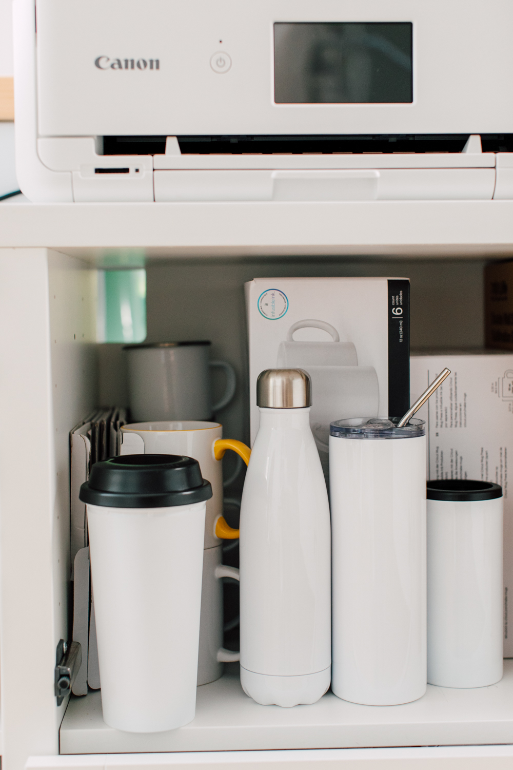 Close up of sublimation tumblers in cabinet.