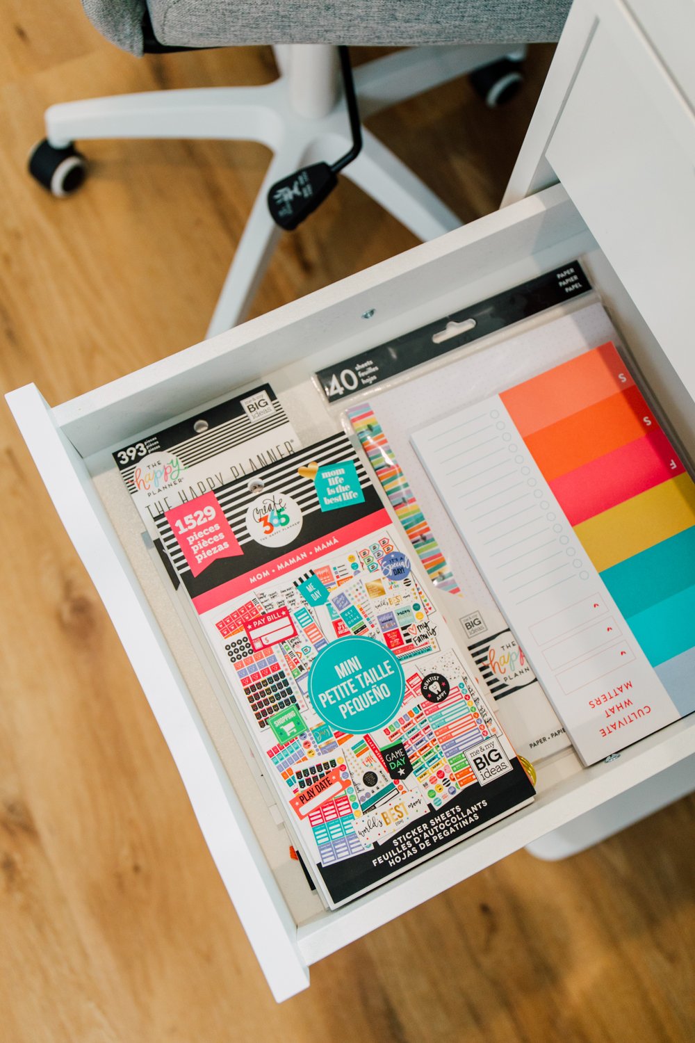 Closeup of drawer contents—notebooks and stickers