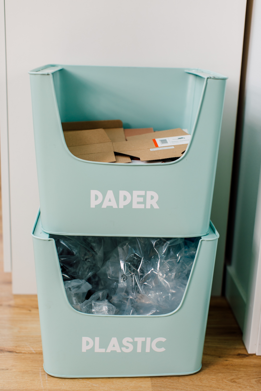 Stack of recycling bins in craft room for paper and plastic