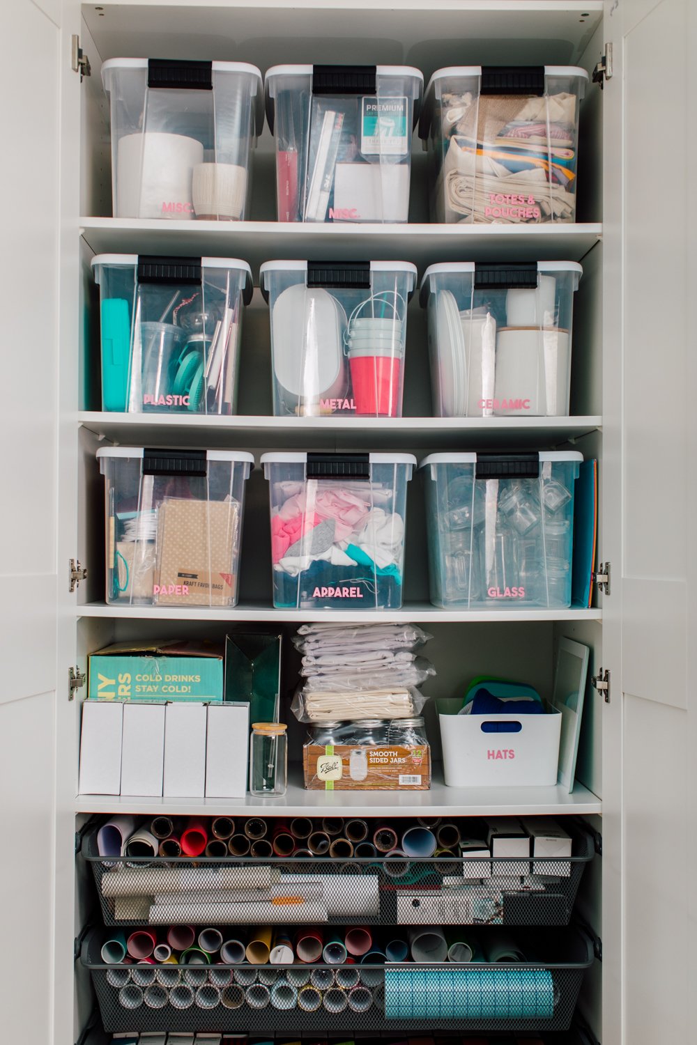 Craft room tour: IKEA Pax cabinet open with nine labeled bins and other supplies.