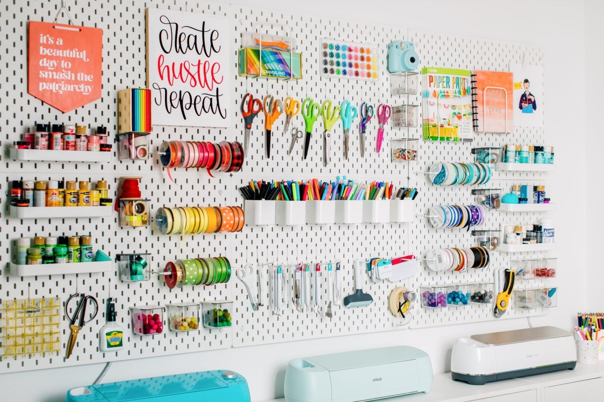 Ikea peg board with lots of colorful tools and materials.