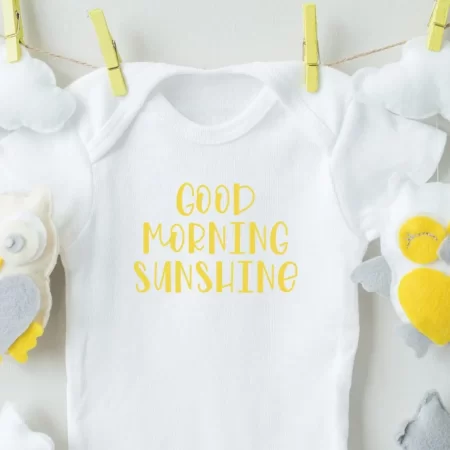 White onesie with yellow wording that says Good Morning Sunshine