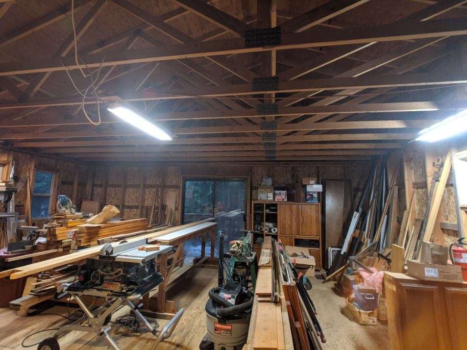 Room before—all studs with wood shop tools and boards all around.