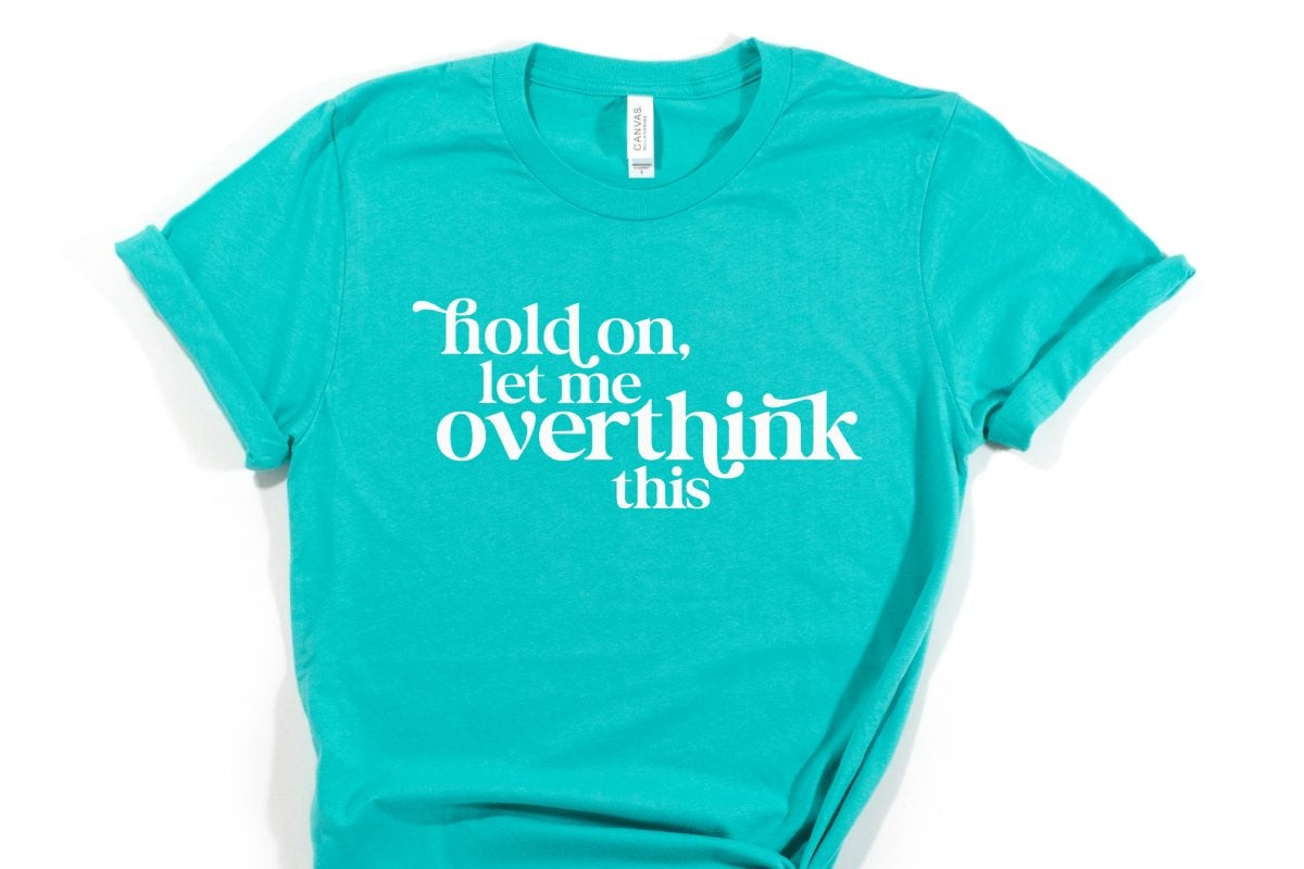 Aqua colored t-shirt with the saying Hold On, Let Me Overthink This