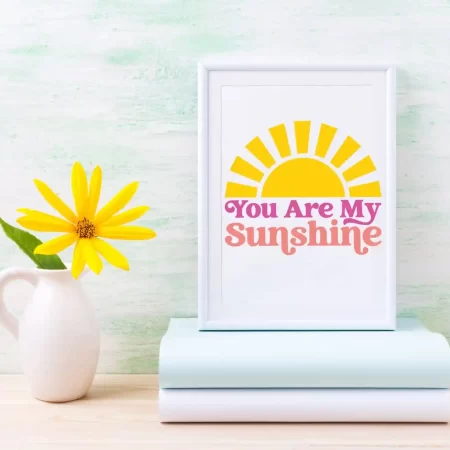 White framed sign that has a sun on it along with the words, You are My Sunshine