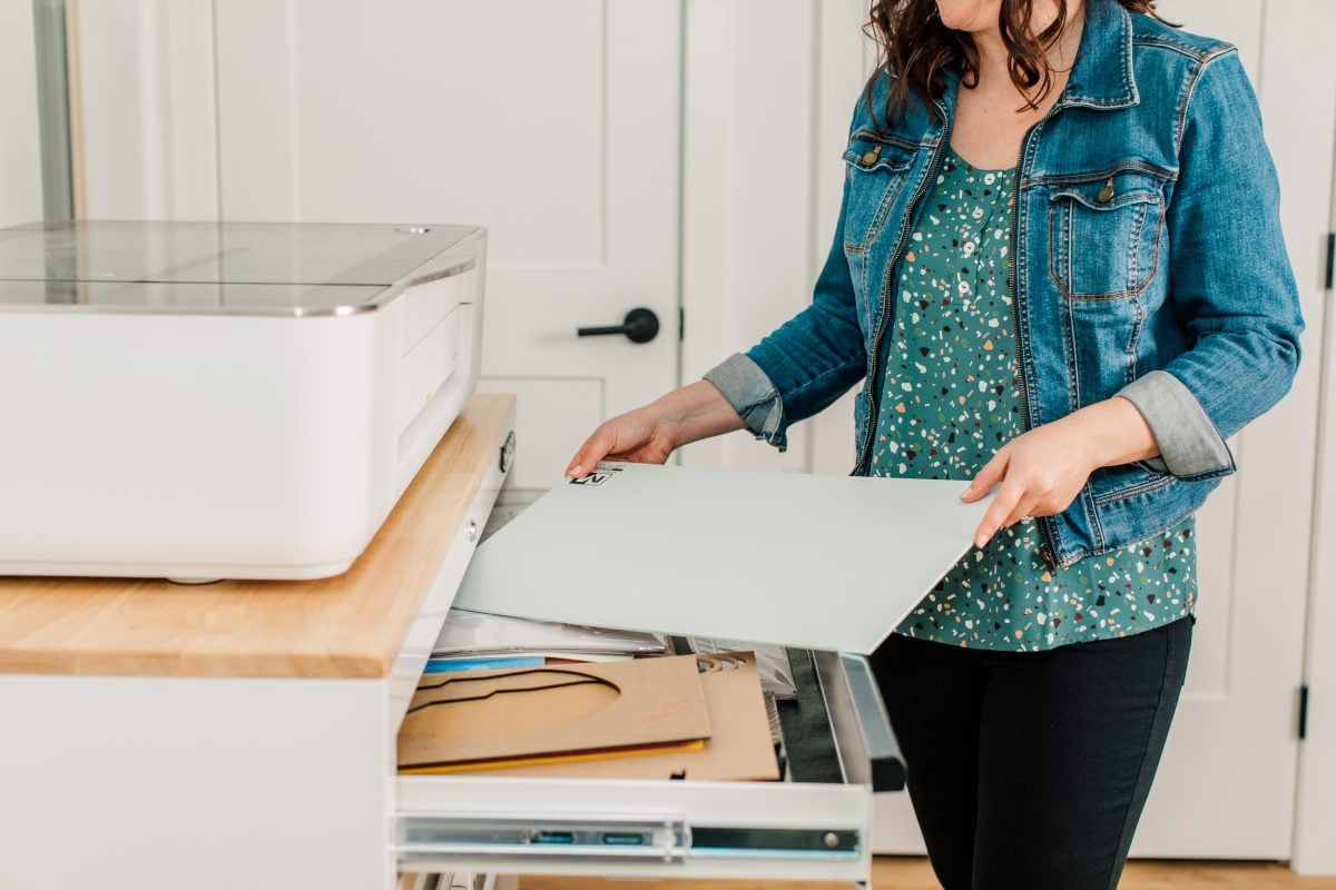 Craft room tour: Cori George removing materials from husky cabinet.