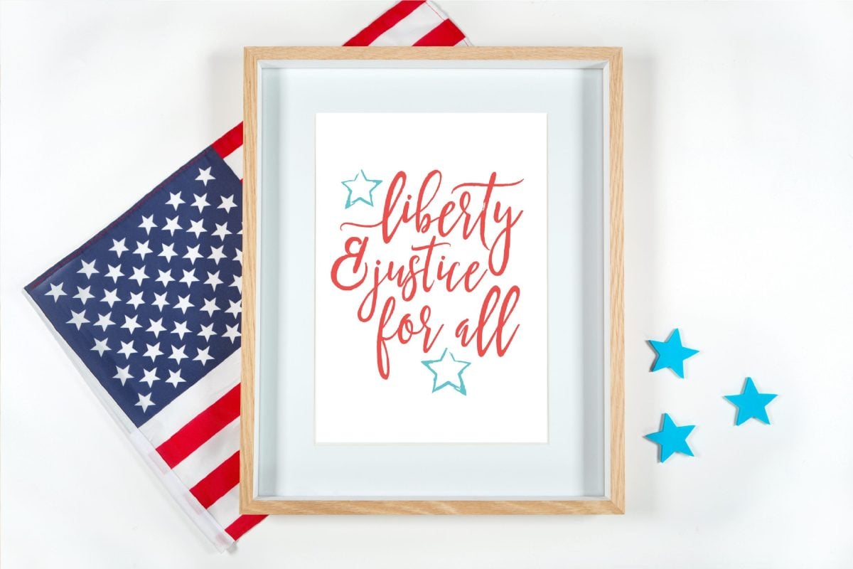 Liberty and Justice for All quote framed with American flag.