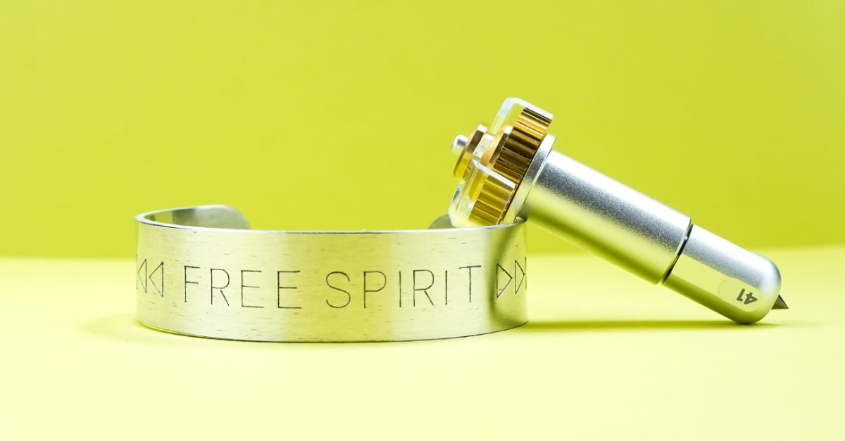 Cricut Engraving Tool with metal bracelet with "free spirit" engraved into it.