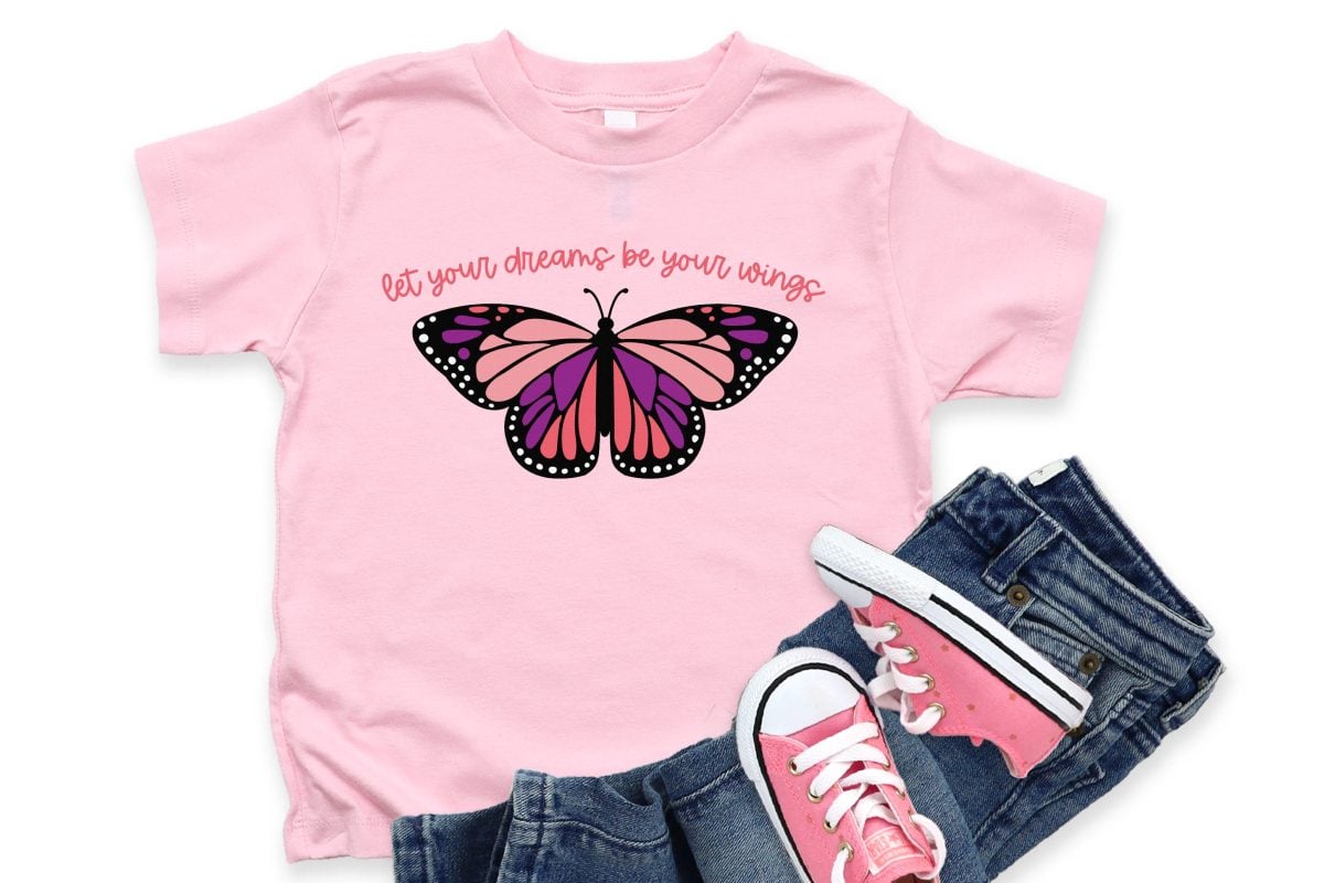 "Let Your Dreams Be Your Wings" butterfly image on pink shirt