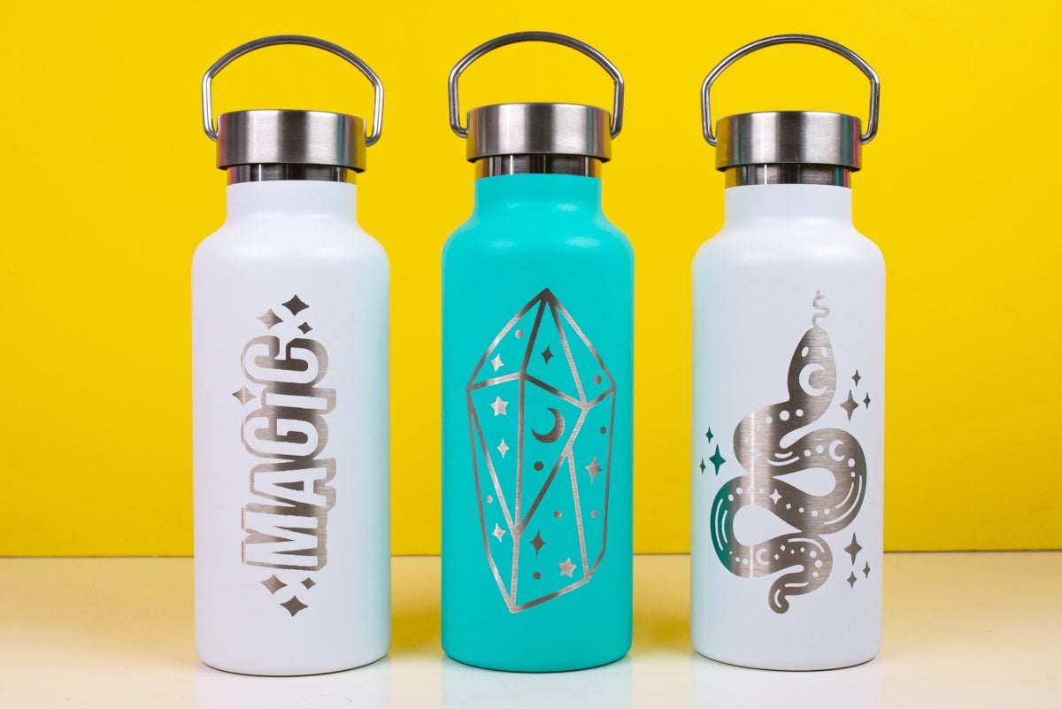 Three tumblers with "magical" types of images etched out of the front.