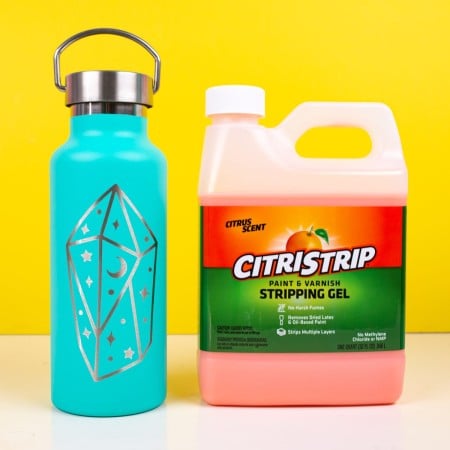 Aqua blue tumbler next to a container of CitriStrip