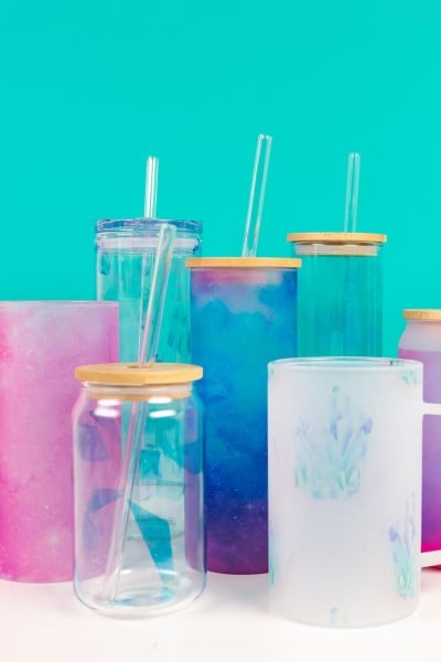 Glass tumblers with sublimation images, with teal background.