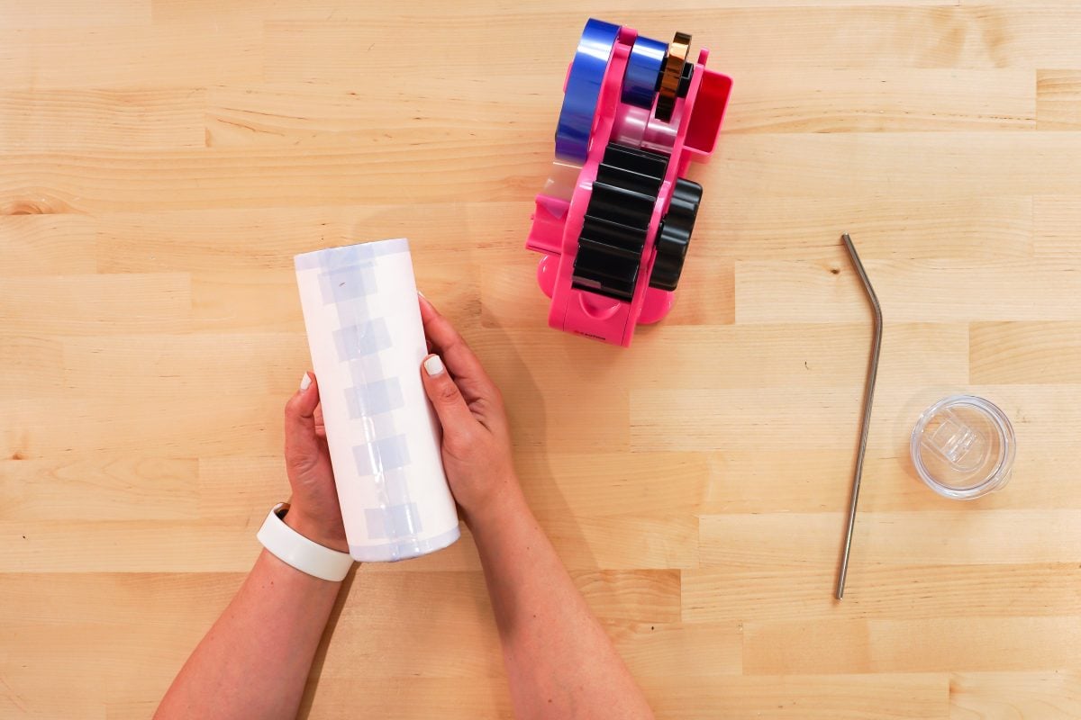 Hands taping the tumbler