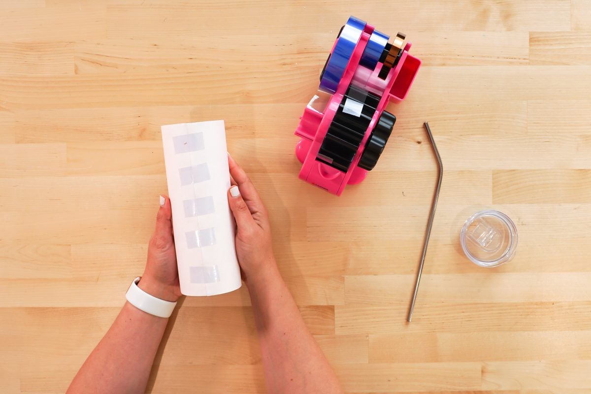 Hands taping the tumbler