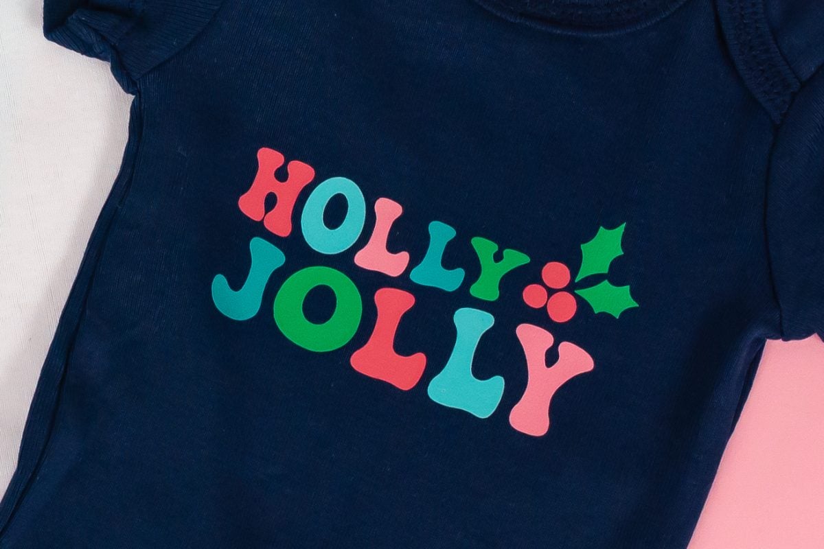 Navy onesie with Holly Jolly.
