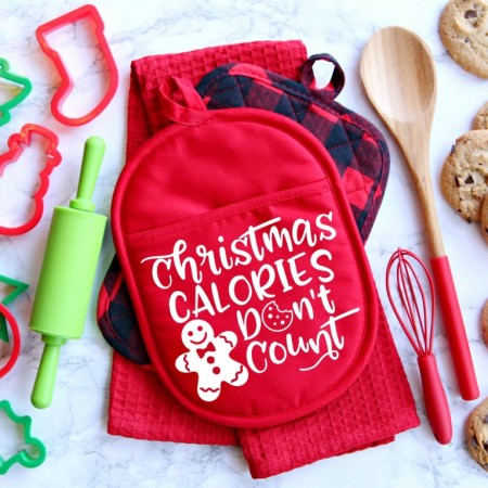 A red oven mitt that says Christmas Calories Don't Count