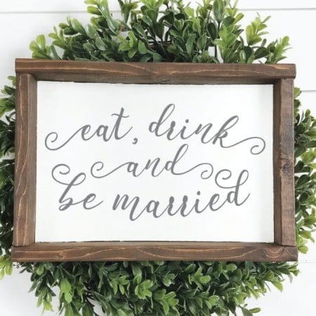 Wood framed sign that says Eat, Drink, and be Married