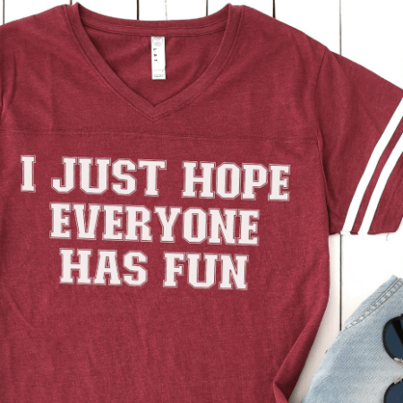 Maroon colored t-shirt with the saying I Just Hope Everyone Has Fun on it