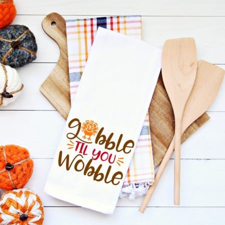 White kitchen towel with the words Gobble 'til you Wobble on it