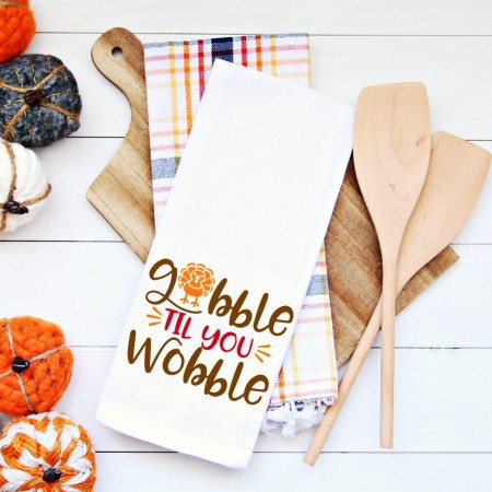 White kitchen towel with the words Gobble 'til you Wobble on it