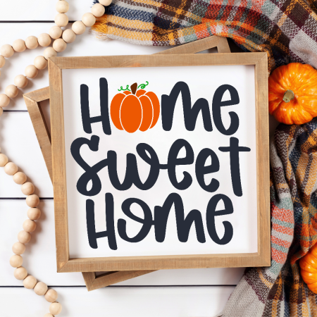 Framed white sign with an image of a pumpkin and the words Home Sweet Home