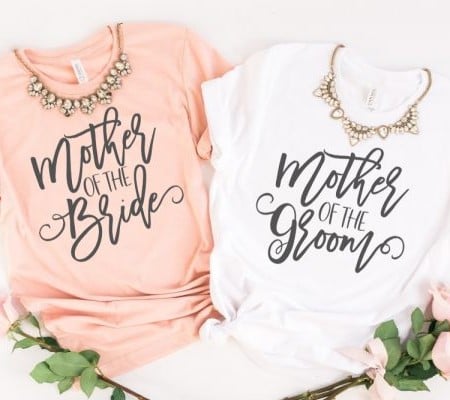Peach colored shirt that says Mother of the Bride and a white shirt that says Mother of the Groom