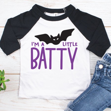 Black and white baseball style shirt with the saying I'm a Little Batty
