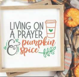 Framed white sign that says Living on a Prayer and Pumpkin Spice