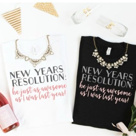 A black t-shirt and a white t-shirt both with the words NEW YEARS RESOLUTION: BE JUST AS AWSOME AS I WAS LAST YEAR!