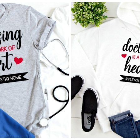 Gray shirt and white shirt that say Nursing/Doctoring is a Work of Heart
