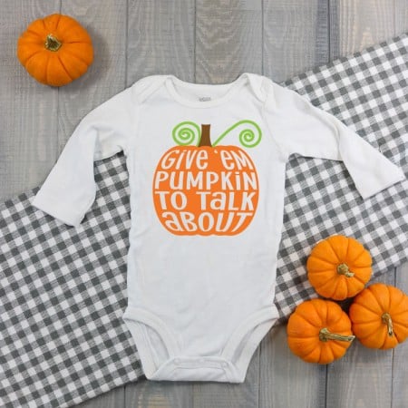 White long sleeved onesie with an image of a large pumpkin on it and the words, Give Them Pumpkin to Talk About