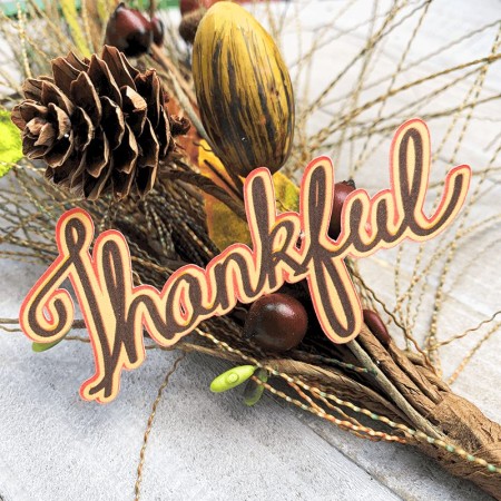The word Thankful on top of a fall bouquet