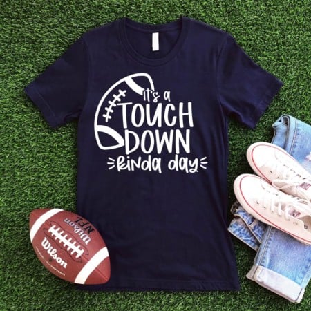 Dark blue t-shirt with an image of a football on it and the words It's a Touchdown Kinda Day