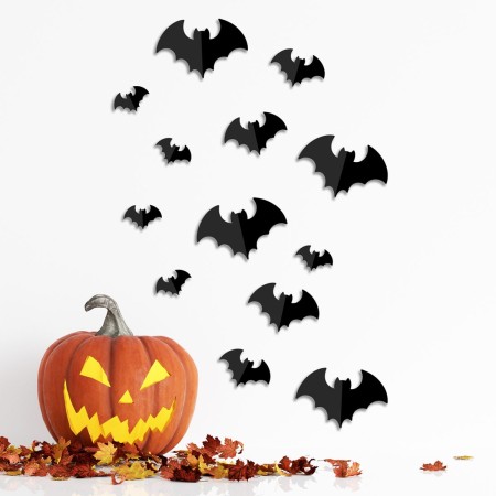 Paper bats on wall with pumpkin