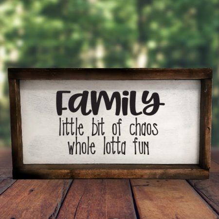 Farmhouse style sign that says Family Little Bit of Chaos Whole Lotta Fun