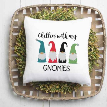 A white pillow decorated with 4 gnomes and the saying Chillin' with my Gnomes