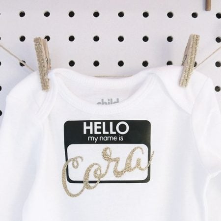 White onesie with a Hello My Name is Cora design on it
